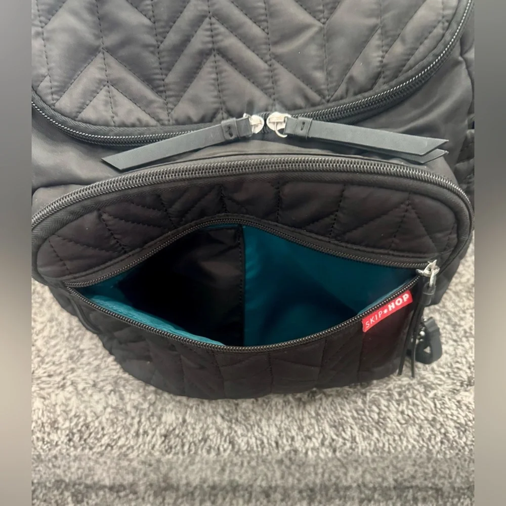 Skip Hop Forma Diaper Backpack. Black Exterior with Teal Interior.